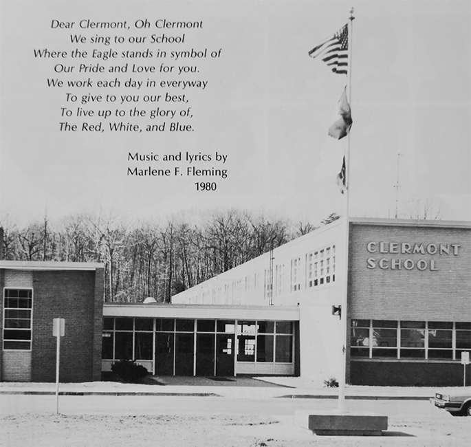 Photograph of a printing of the school song in a yearbook. The lyrics read Dear Clermont, Oh Clermont, We sing to our School, Where the Eagle stands in symbol of, Our Pride and Love for you. We work each day in every way, To give to you our best, To live up to the glory of, The Red, White, and Blue. Music and lyrics by Marlene F. Fleming, 1980.