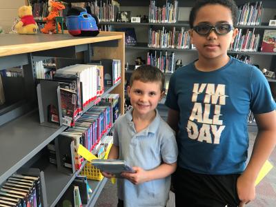 two boys smiling in library