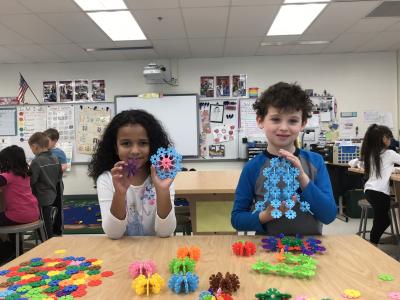 boy and girl show off their creations