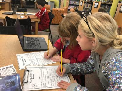 students finding books with a library catalog