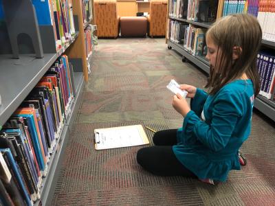 students finding books with a library catalog