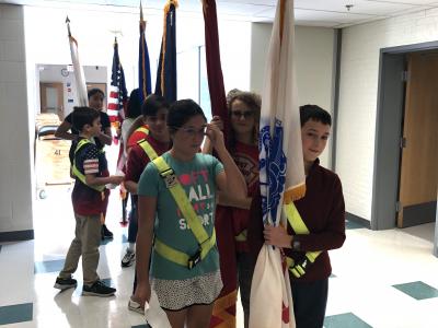 Patrols holding the different military branches flags.