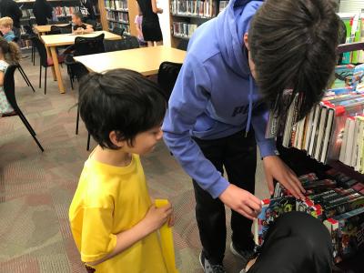 boys checkout books in library